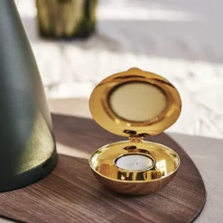 Shell votive, brass